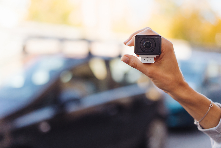 person holding a remote video surveillance camera