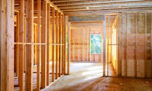 The framed, uncompleted walls of a secure home construction site