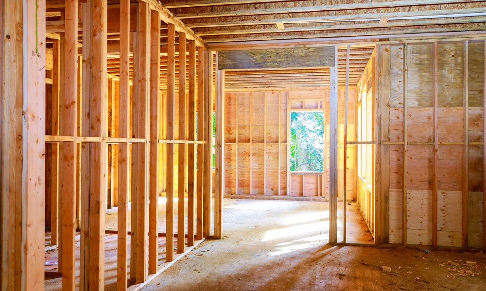 The framed, uncompleted walls of a secure home construction site