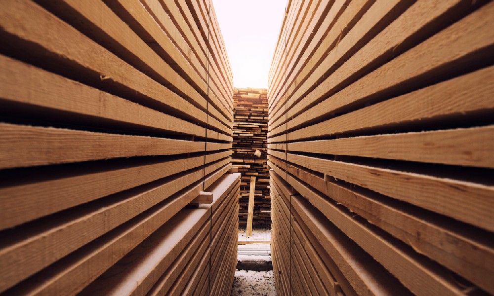 Stacks of wooden planks in a lumber yard, exemplifying the need for mobile security